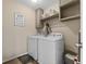 Functional laundry room equipped with a washer, dryer, and storage shelves at 4886 St James Ln, Winter Haven, FL 33881