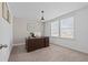 Bright home office featuring a large window and a classic wooden desk at 4886 St James Ln, Winter Haven, FL 33881