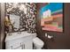 Unique powder room with modern wallpaper, vanity, and decor at 4886 St James Ln, Winter Haven, FL 33881