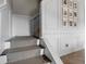 Elegant stairway with carpeted steps and white paneled walls decorated with framed photos at 4886 St James Ln, Winter Haven, FL 33881