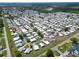Aerial view of a mobile home community with a nearby lake and various amenities at 5015 Fox Cliff Dr, Lakeland, FL 33810