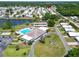 Aerial view of community clubhouse with pool, tennis courts, lush landscaping, and neighborhood streets at 5015 Fox Cliff Dr, Lakeland, FL 33810