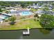 Aerial view of community center with swimming pool and dock extending onto the lake at 5015 Fox Cliff Dr, Lakeland, FL 33810