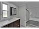 Modern bathroom offers granite-topped vanity and tiled tub-shower with glass doors at 5015 Fox Cliff Dr, Lakeland, FL 33810