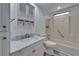 Bright bathroom features a marble-top vanity and tub with wall-mounted shower at 5015 Fox Cliff Dr, Lakeland, FL 33810