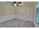 Cozy bedroom with wood-look flooring, ceiling fan, and neutral paint at 5015 Fox Cliff Dr, Lakeland, FL 33810