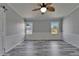 Open bedroom space with wood-look floors and bright windows for ample natural light at 5015 Fox Cliff Dr, Lakeland, FL 33810