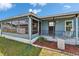 Charming blue home featuring a sunroom and an inviting front porch with a rocking chair at 5015 Fox Cliff Dr, Lakeland, FL 33810