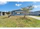 Cozy single-story home featuring a carport and landscaped front yard under a bright blue sky at 5015 Fox Cliff Dr, Lakeland, FL 33810
