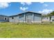 Exterior view of a blue mobile home with a fenced yard and blue skies at 5015 Fox Cliff Dr, Lakeland, FL 33810