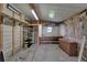 Unfinished garage with pegboard wall, shelves, workbench, overhead storage, and bare insulation at 5015 Fox Cliff Dr, Lakeland, FL 33810