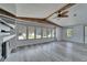 Sun-filled living room with multiple windows, fireplace, and wood-look flooring at 5015 Fox Cliff Dr, Lakeland, FL 33810