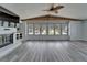 Bright living room featuring a fireplace, large windows, and wood-look floors at 5015 Fox Cliff Dr, Lakeland, FL 33810