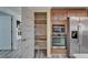 Walk-in pantry with shelving alongside modern stainless steel appliances in the kitchen at 5015 Fox Cliff Dr, Lakeland, FL 33810