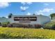 Signage for Foxwood Lake Estates, a senior deed-restricted community with manicured landscaping at 5015 Fox Cliff Dr, Lakeland, FL 33810