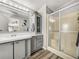 Bright bathroom with a vanity, storage cabinets, and a shower with sliding glass doors at 5016 Forest Crest Dr, Lakeland, FL 33810