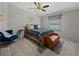 Comfortable bedroom featuring a patterned bedspread, a chair and storage chest at 5016 Forest Crest Dr, Lakeland, FL 33810
