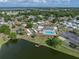 Wide aerial view of a sprawling community featuring a lake, clubhouse, pool, and recreation area at 5016 Forest Crest Dr, Lakeland, FL 33810