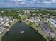 Wide aerial view showcases community by lake, lush greenery, clubhouse, pool and recreation area at 5016 Forest Crest Dr, Lakeland, FL 33810