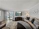 Spacious living room featuring a sectional sofa, modern television, and access to an enclosed patio at 5016 Forest Crest Dr, Lakeland, FL 33810