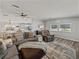 Cozy living room with a large sectional, ceiling fan, and adjacent dining area and kitchen at 5016 Forest Crest Dr, Lakeland, FL 33810