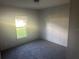This carpeted bedroom has a large window allowing for plenty of natural light at 5248 Rock Dove Trl, Lakeland, FL 33810