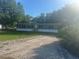 Well-maintained single-story home with gray siding and black shutters in a wooded area at 5248 Rock Dove Trl, Lakeland, FL 33810