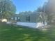 Green single-story home with white accents, showcasing a well-manicured lawn at 5248 Rock Dove Trl, Lakeland, FL 33810