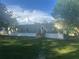 Green single-story home with white accents, surrounded by lush greenery at 5248 Rock Dove Trl, Lakeland, FL 33810