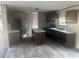Modern kitchen featuring stainless steel appliances, dark wood cabinets, and an island at 5248 Rock Dove Trl, Lakeland, FL 33810