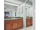 Bathroom featuring wood vanity, tile floor, large mirror, and natural light at 537 Eagle Run, Lakeland, FL 33809