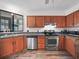 Cozy kitchen with stainless appliances, laminate floors and wooden cabinets with ample counter space at 537 Eagle Run, Lakeland, FL 33809