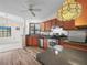 Kitchen with wooden cabinets, stainless steel appliances and laminate flooring at 537 Eagle Run, Lakeland, FL 33809