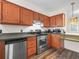 Functional kitchen equipped with stainless steel appliances and dark laminate flooring at 537 Eagle Run, Lakeland, FL 33809