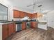 Kitchen features stainless steel appliances, wooden cabinetry, and durable laminate flooring at 537 Eagle Run, Lakeland, FL 33809