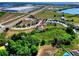 An aerial view showcases a home with a large, private backyard space bordered by mature trees and lush landscaping at 5793 Dornich Dr, Auburndale, FL 33823
