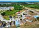 An aerial view showcases a home in a well-maintained neighborhood near major thoroughfares and green spaces at 5793 Dornich Dr, Auburndale, FL 33823