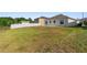 View of the backyard showcasing the vinyl fencing and lawn at 5793 Dornich Dr, Auburndale, FL 33823