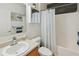 Bright bathroom featuring a single vanity, shower with tub and a medicine cabinet at 5793 Dornich Dr, Auburndale, FL 33823