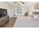 Spacious bedroom features a ceiling fan, tray ceiling, and wood-look flooring at 5793 Dornich Dr, Auburndale, FL 33823