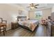 Spacious bedroom features a ceiling fan, tray ceiling, and wood-look flooring at 5793 Dornich Dr, Auburndale, FL 33823