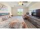 Spacious bedroom features a ceiling fan, tray ceiling, and wood-look flooring at 5793 Dornich Dr, Auburndale, FL 33823