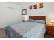 Comfortable bedroom with wood-look floors, neutral colors, and a large closet at 5793 Dornich Dr, Auburndale, FL 33823