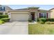 Charming single-story home featuring a two car garage, stone accents, and a well-manicured front yard at 5793 Dornich Dr, Auburndale, FL 33823