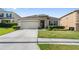 Well-maintained house with a two-car garage and professionally landscaped front yard at 5793 Dornich Dr, Auburndale, FL 33823