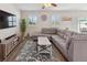 Inviting living room with modern gray sectional sofa, neutral walls, and stylish decor at 5793 Dornich Dr, Auburndale, FL 33823