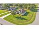 Aerial view of a home with a large yard, mature trees, and a long driveway at 6372 English Creek Dr, Lakeland, FL 33811