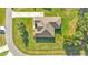Overhead angle of the single-story home with an angular roof design, surrounded by an expansive green lawn at 6372 English Creek Dr, Lakeland, FL 33811