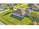 View of the home with a covered patio and spacious green lawn and a meticulously manicured garden at 6372 English Creek Dr, Lakeland, FL 33811