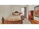 Cozy bedroom featuring a decorative bed, dark wooden furniture, and neutral decor at 6372 English Creek Dr, Lakeland, FL 33811